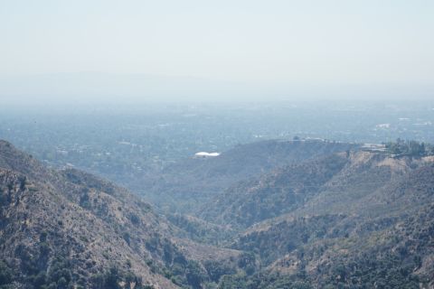 1995 Ford Taurus - Distant view of a cityscape among hills, partially obscured by haze.