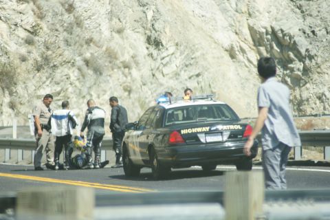1995 Ford Taurus - Highway Patrol officers attend to motorcyclists after an apparent incident on a mountain road.