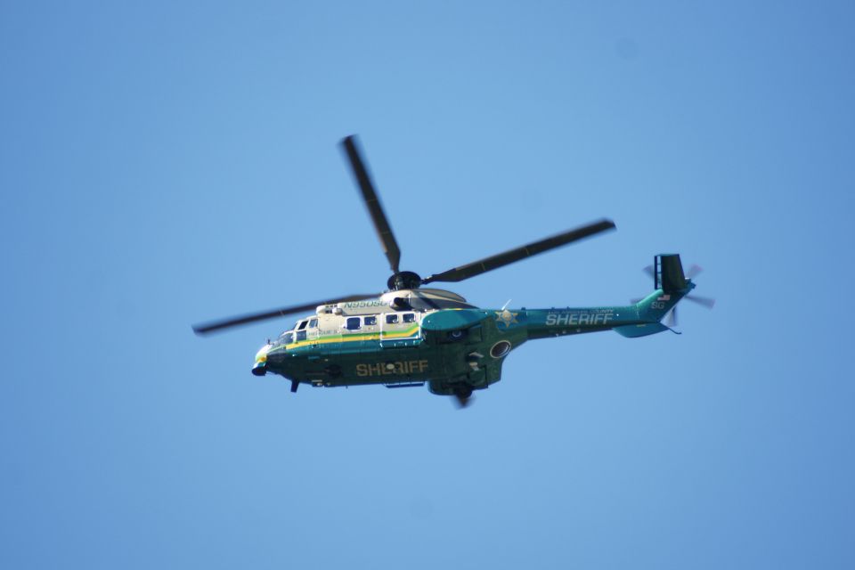 Sheriff helicopter in flight against a clear blue sky