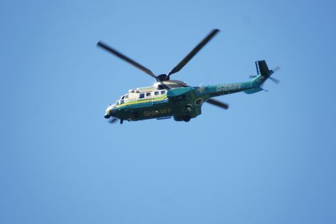 1995 Ford Taurus - A Sheriff's department helicopter is seen in flight against a bright blue sky.