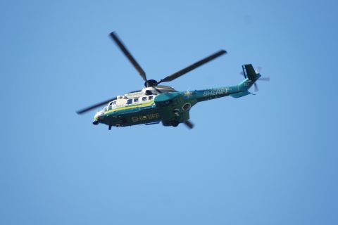 1995 Ford Taurus - A sheriff's helicopter with "SHERIFF" written on its side flies through the air.