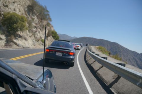 1995 Ford Taurus - A line of cars are stuck in traffic on a scenic mountain highway.