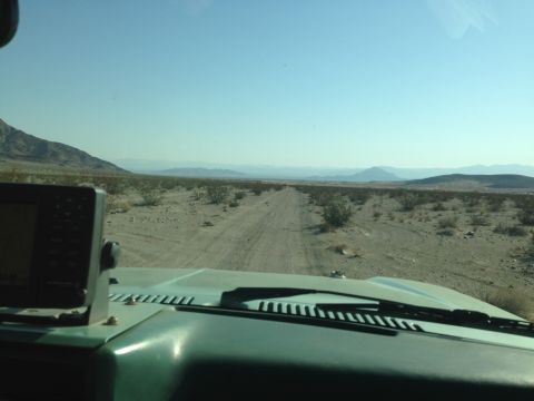 1986 Ford Bronco - Driving through a desert landscape on a dirt road, with a GPS unit visible on the dashboard.