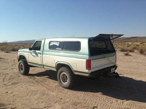 1986 Ford Bronco - This Ford F-Series pickup truck, likely from the early 1980s, is equipped for off-road use in a desert environment.