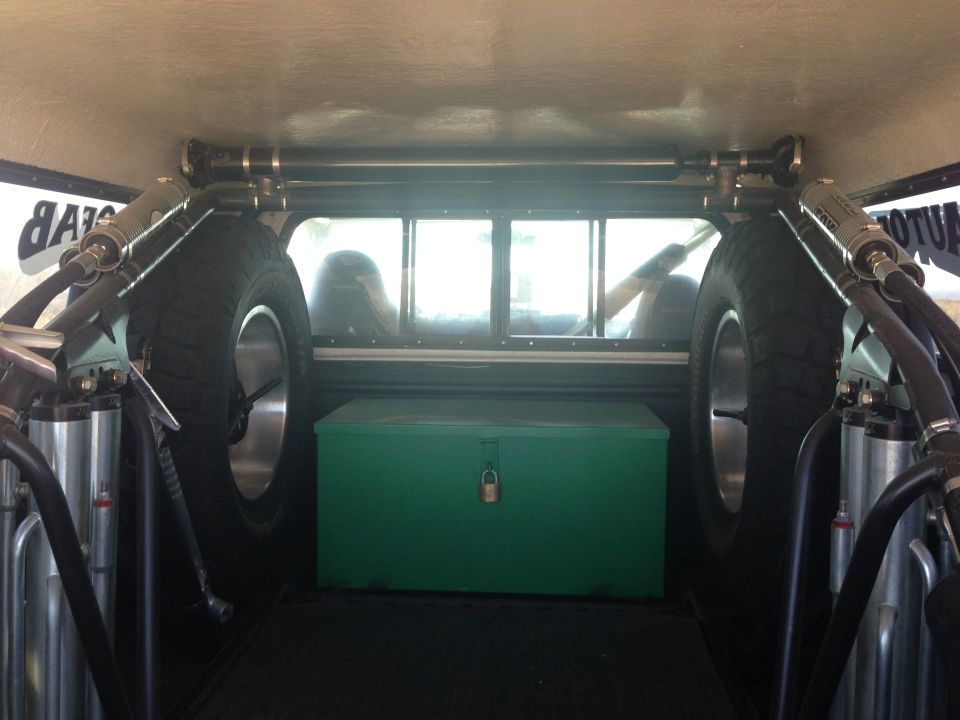 Interior cargo area with spare tires and green toolbox