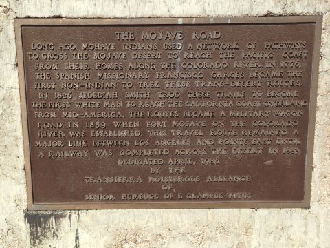 1986 Ford Bronco - A historical plaque about the Mojave Road, dedicated in 1986, is mounted on a stone surface.