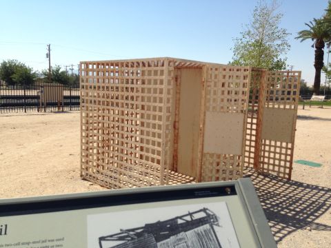 1986 Ford Bronco - Exhibit of a historic two-cell jail structure in an outdoor setting.