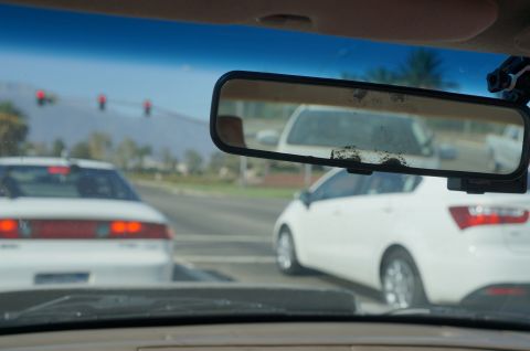 1995 Ford Taurus - Driving in traffic, seen through the windshield and rear-view mirror.