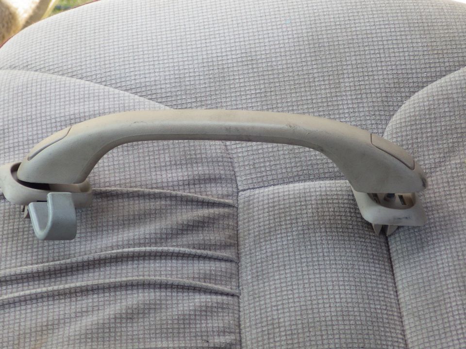 I chose these comfort handles (possibly from a Crown Vic, Taurus, or Explorer) because their bases are designed with standoffs to work through a headliner.  They aren't particularly strong for pulling up into a tall truck, but for my installation, they don't need to be.