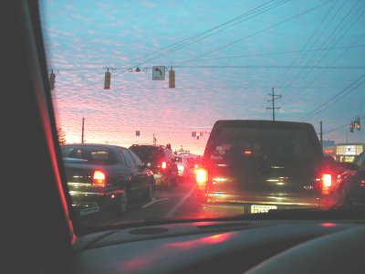 1997 Ford Taurus - Cars are stopped in traffic during a colorful sunset.