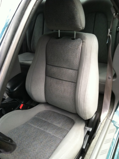 1997 Ford Probe - Interior view of a car's front seats and seatbelt, showing gray fabric upholstery.
