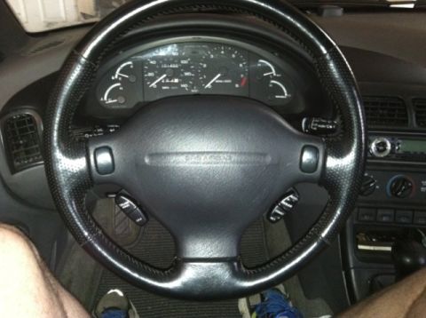 1997 Ford Probe - View of the driver's side interior, focusing on the steering wheel and instrument cluster.