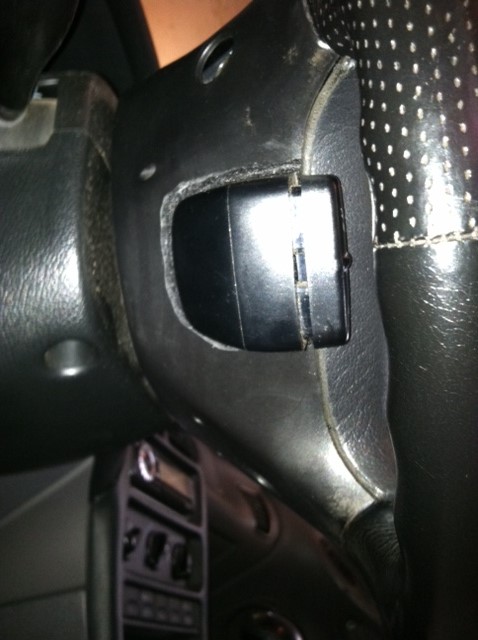 1997 Ford Probe - Close-up of an interior component, possibly a switch or cover, located near the steering column.
