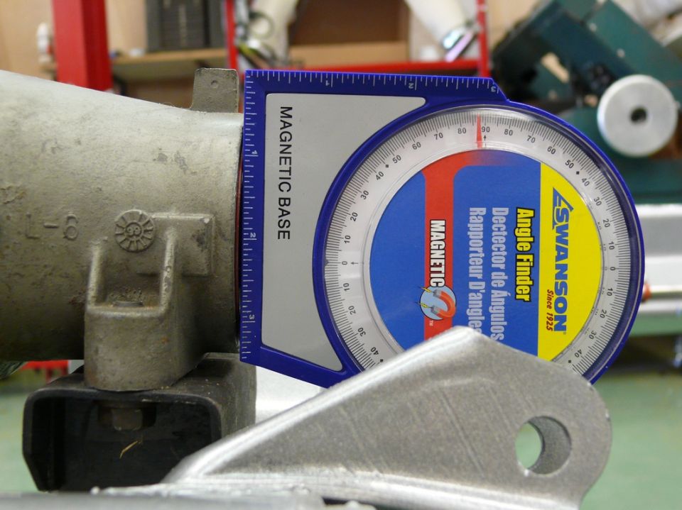 Angle finder on a metal component with markings 'L-6'