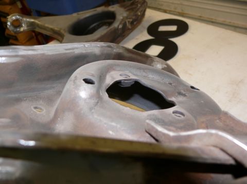 1976 Chevrolet Corvette - Automotive suspension parts, possibly from a classic car, are shown in detail on a work surface.