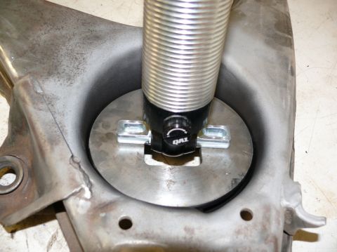 1976 Chevrolet Corvette - Close-up of a QA1 shock absorber assembly mounted to a vehicle's suspension part.