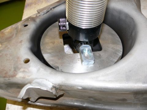 1976 Chevrolet Corvette - A close-up view shows a tool engaging with a vehicle's suspension component.