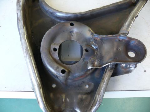 1976 Chevrolet Corvette - Close-up of a vehicle's suspension control arm, a metal component with various holes and welded joints.