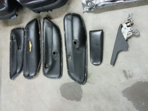 2002 Volkswagen Jetta - Collection of automotive interior door trim pieces and panels on a floor.