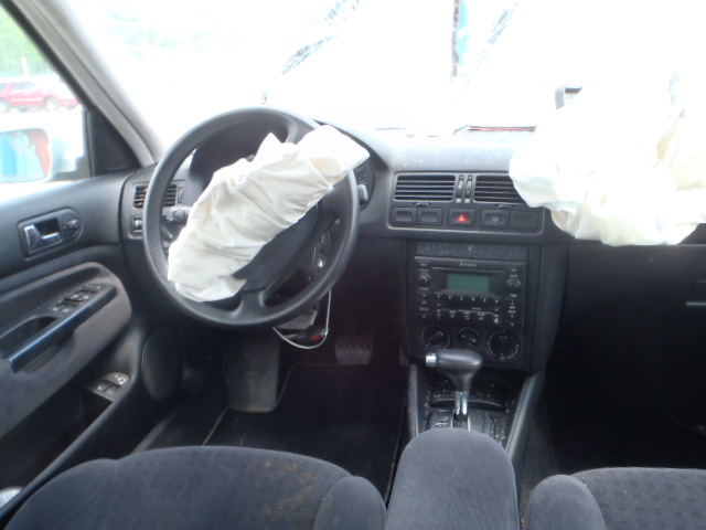 2002 Volkswagen Jetta interior showing deployed driver and passenger airbags, steering wheel, and dashboard