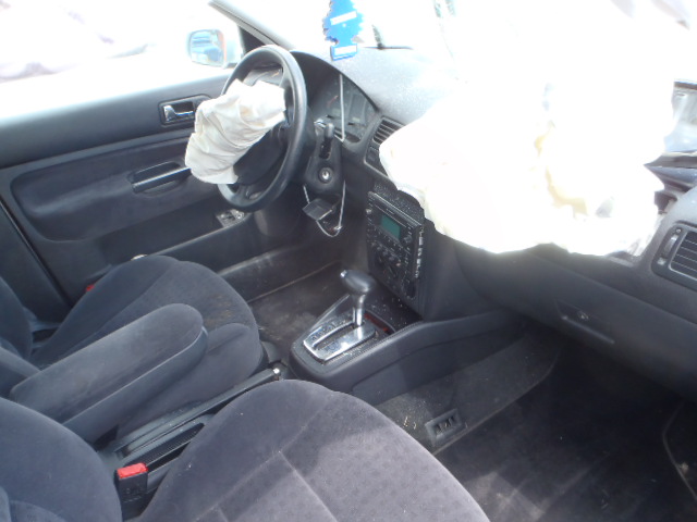 Interior of a 2002 Volkswagen Jetta with deployed airbags, dark fabric seats, and a central console