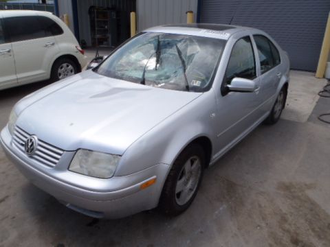 2002 Volkswagen Jetta - A silver 2002 Volkswagen Jetta with a damaged windshield is parked next to a white vehicle.