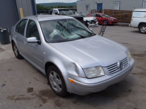 2002 Volkswagen Jetta - Silver 2002 Volkswagen Jetta shows damage to the front fender and a severely cracked windshield.