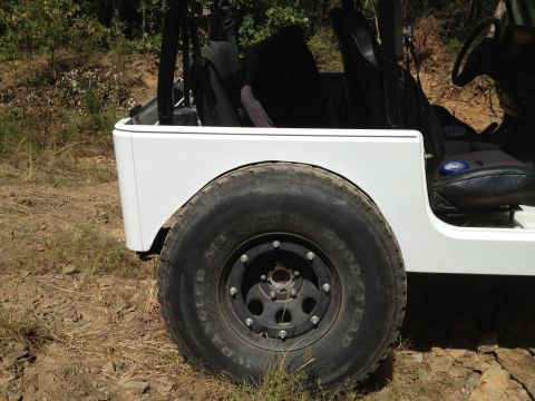 2000 Jeep TJ - A white Jeep's side profile is shown with a large tire and black rim.