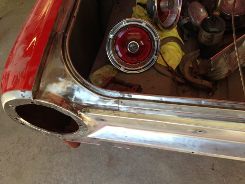 1964 Ford Fairlane - The rear of a 1964 Ford Fairlane shows its trunk area undergoing restoration with parts laid out.