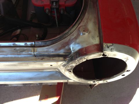 1964 Ford Fairlane - The rear wheel well area of a 1964 Ford Fairlane shows signs of restoration work, with exposed metal and primer.