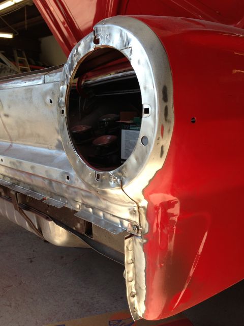 1964 Ford Fairlane - The rear of a 1964 Ford Fairlane is shown with bodywork in progress, revealing unpainted metal and repair patches.