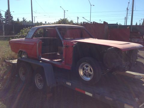 1964 Ford Fairlane - This 1964 Ford Fairlane coupe body is being transported on a trailer, stripped down and awaiting restoration.
