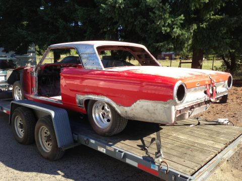 1964 Ford Fairlane - A red 1964 Ford Fairlane coupe project car is being transported on a trailer.