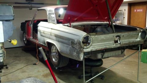 1964 Ford Fairlane - A 1964 Ford Fairlane is shown in a garage with its hood and doors open, indicating it is in the process of restoration.