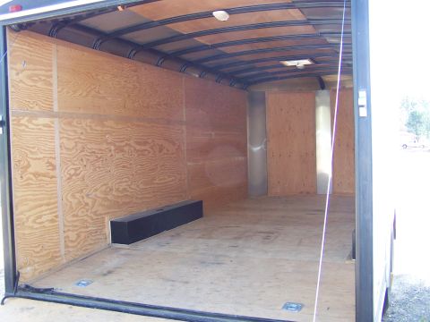 1988 Suzuki Samurai - Interior view of an empty cargo trailer, showing wood paneling on walls and ceiling.