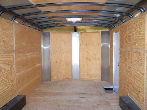 1988 Suzuki Samurai - The inside of a cargo trailer is shown, unfinished wood paneling on the walls and ceiling.