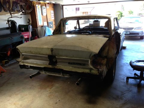 1964 Ford Fairlane - Rear view of a 1964 Ford Fairlane in a garage, showing its condition during restoration.