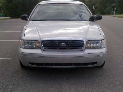 2001 Ford Crown Victoria - Front view of a silver 2001 Ford Crown Victoria, a chrome grille and distinctive headlights.