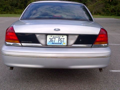 2001 Ford Crown Victoria - Rear view of a silver 2001 Ford Crown Victoria, displaying its distinctive taillights and license plate.