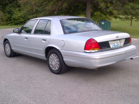 2001 Ford Crown Victoria - Rear view of a silver 2001 Ford Crown Victoria sedan parked outdoors.