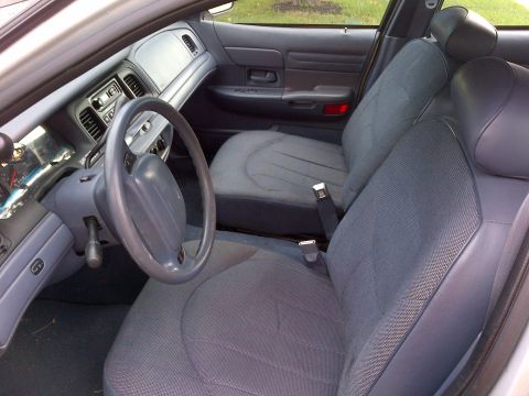 2001 Ford Crown Victoria - Interior view of a 2001 Ford Crown Victoria, showing the front seats and dashboard.