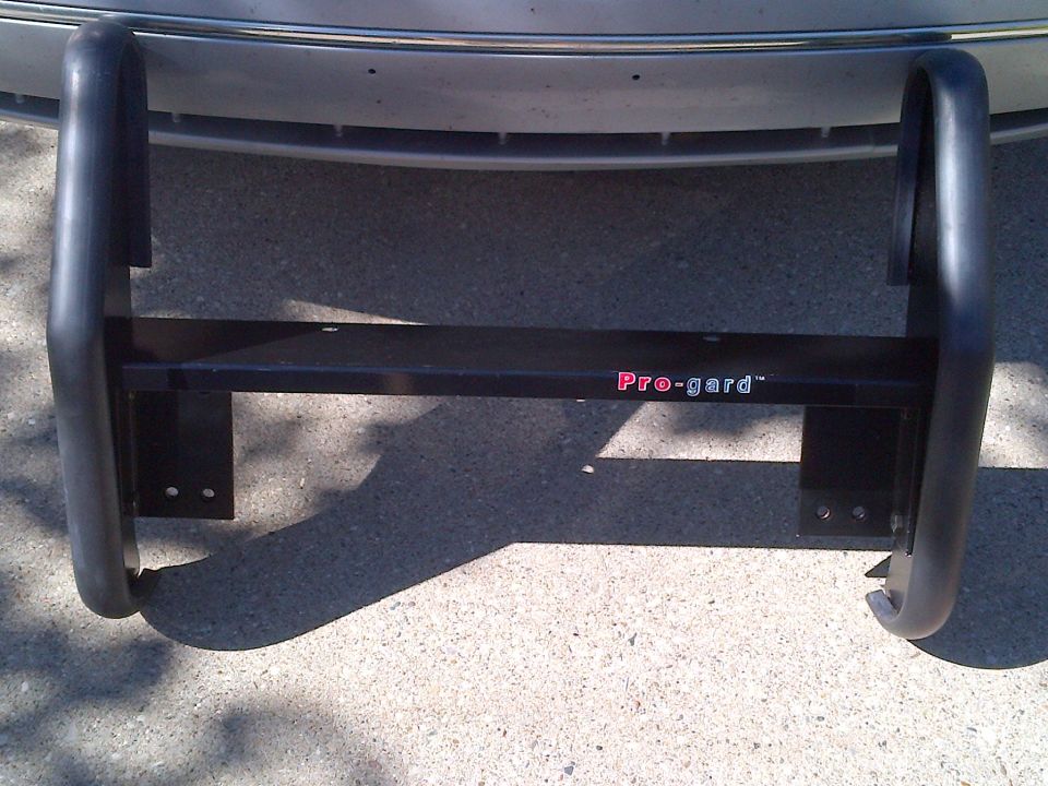 Black Pro-gard bull bar mounted to a vehicle bumper