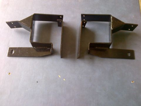 2001 Ford Crown Victoria - Two black metal brackets, possibly for a vehicle, are displayed on a gray surface. The bottom right corner shows a 'SUPERMOTORS.NET' waterm…
