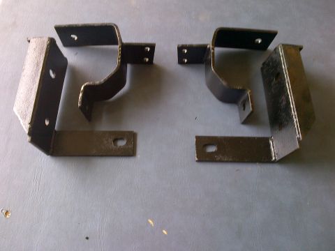 2001 Ford Crown Victoria - Two metal brackets are shown on a gray surface.