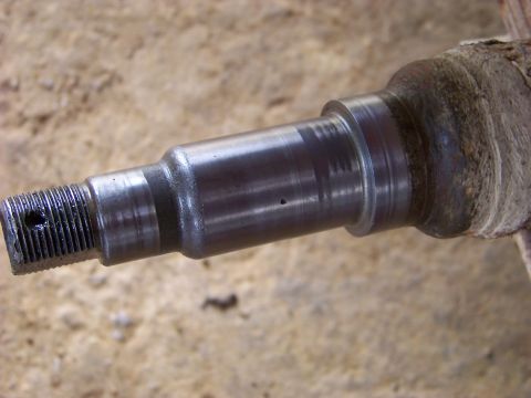 1995 Mercury Grand Marquis - Close-up of a metal spindle, a component of a vehicle's suspension system.