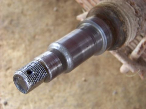 1995 Mercury Grand Marquis - A close-up view of a metal spindle, likely a vehicle part, with visible threading on one end.