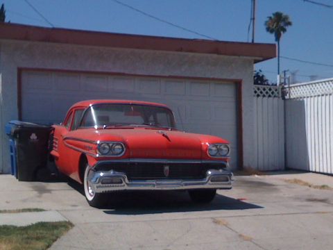 1968 Ford Mustang - This 1958 Oldsmobile Super 88 is parked in front of a garage.