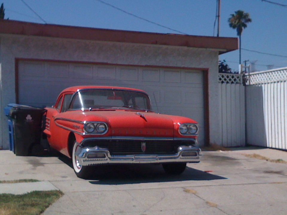 Red 1958 Oldsmobile Super 88 front view parked in driveway