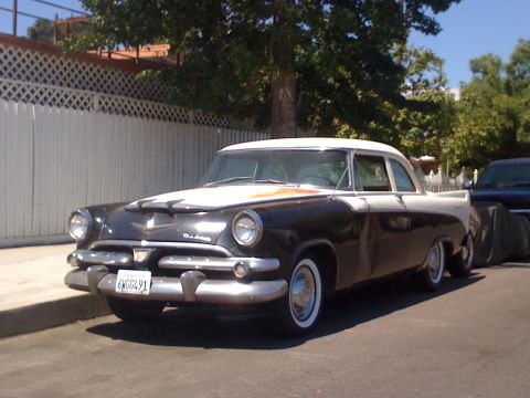 1968 Ford Mustang - This two-tone 1955 Dodge sedan is parked curbside on a sunny day.