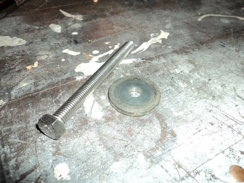 Bolt and washer on a stained workbench surface